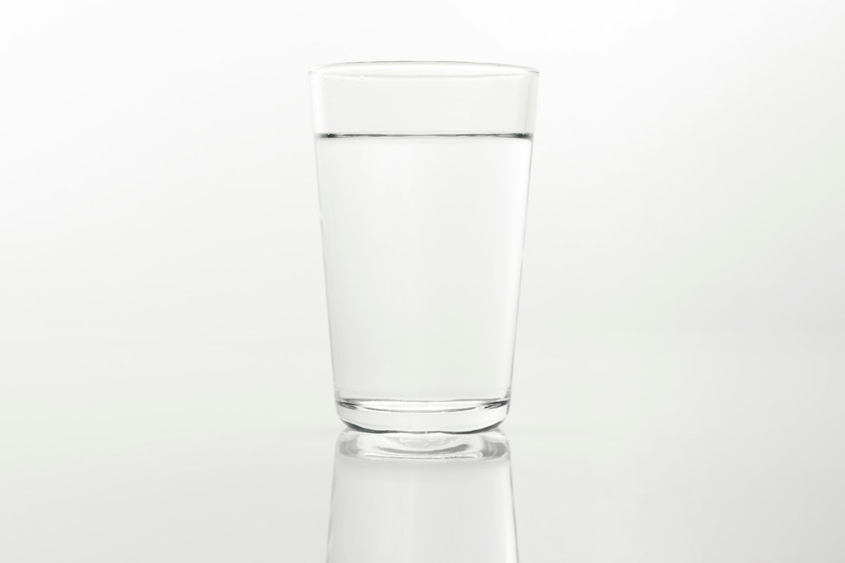 A clear glass of water on a white surface